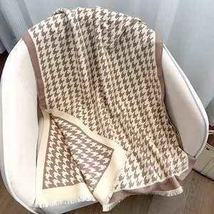 Classic houndstooth patterned winter scarf in beige and brown with elegant fringe detail