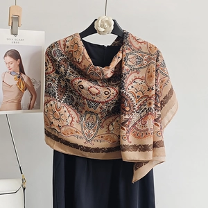 Detail of vintage paisley pattern cotton scarf showing silk texture and elegant draping