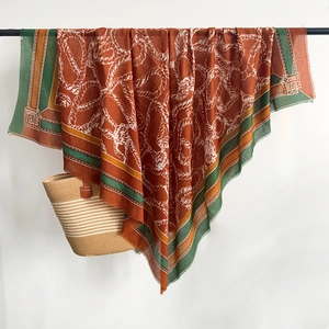Close-up of bohemian rope pattern scarf with fringe edges and tassels on high quality linen