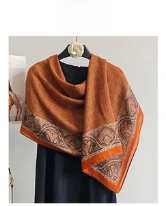 Detail of vibrant orange cotton linen scarf featuring vintage paisley and geometric patterns