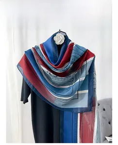 Detail view of the elegant red and blue silk scarf with classical European geometric patterns