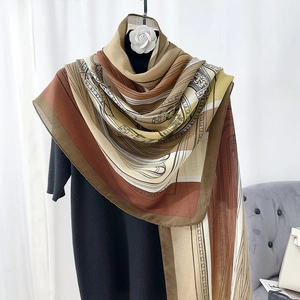 Close-up of printed silk-feel scarf draped on a mannequin showing retro horse motif
