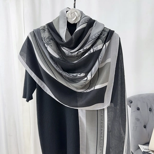 Detail of floral chain print shawl with camellia clip decoration on white curtain background
