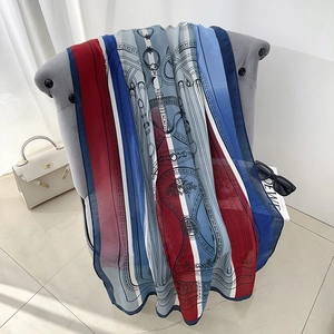 Elegant cotton linen scarf with vintage chain patterns draped over a velvet chair