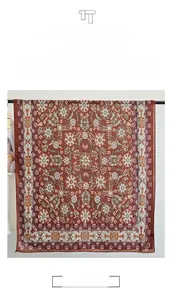 Detail view of ethnic paisley print shawl showing smooth texture and thick brick red fabric