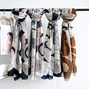 Elegant floral print scarves set with rose patterns and geometric design in neutral tones