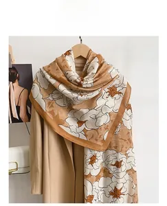 Detailed texture of a brown and beige floral cotton-linen scarf draped on a coat
