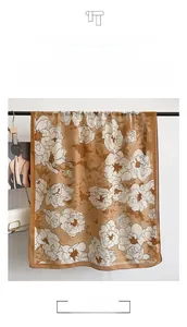 Detail of floral linen scarf showing silky fabric texture and pastoral blue rose print