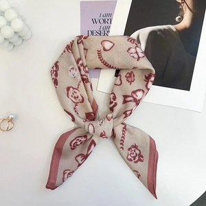Detail of silk-feel scarf with floral bear patterns and light luxury French style texture