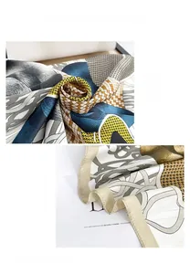 Detail showing smooth silk texture and fine hand-rolled edges of paisley pattern scarf