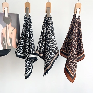 Set of three leopard print silk scarves with striped borders in black, beige, and brown