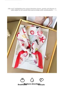 Detail of printed silk scarf with starfish shell patterns in a luxury gold tray setup