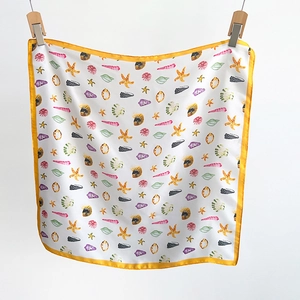 Detail of silk-like square scarf featuring colorful starfish and seashell prints