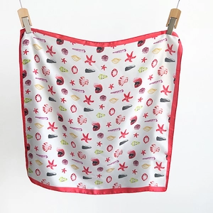 Detail of silk square scarf with starfish and seashell patterns on white silk