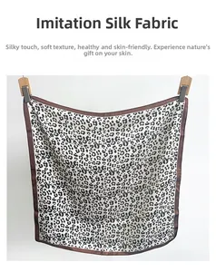 Detail showing the leopard print pattern and smooth imitation silk texture of the scarf