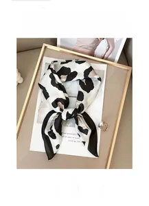 Close-up of leopard print linen scarf with satin finish and soft fabric texture