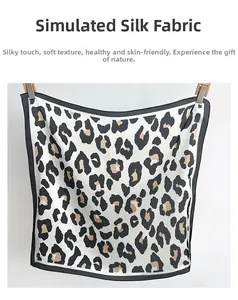 Detail of silk satin leopard print square scarf showing smooth texture and black borders