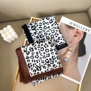 Classic leopard print silk neckerchiefs displayed in elegant decorative frames