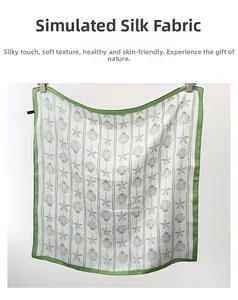 Detail of imitation silk scarf featuring green starfish and seashell patterns on white