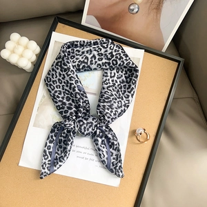 Black and white leopard print silk scarf styled on a luxury decorative frame