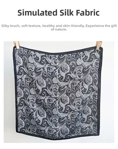 Detailed view of the black and white paisley silk-like fabric with intricate patterns