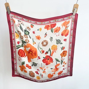 Detail of floral silk square scarf with red border and hand-painted flower pattern