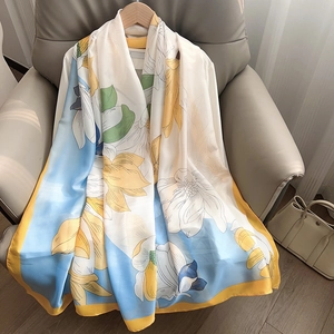Elegant long silk scarf with magnolia print in blue and yellow floral design