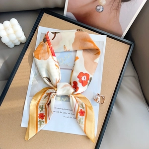 Floral print silk neck scarf with orange and red patterns in elegant flat lay style