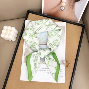 Elegant ivory silk square scarf with bright green ocean motifs like starfish and seashells
