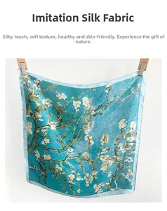 Detail of artistic almond blossom printed silk satin scarf with elegant blue floral patterns