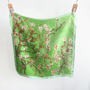 Detail view of Van Gogh almond blossom print on a green satin silk square scarf