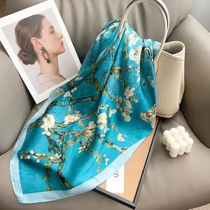 Van Gogh Almond Blossoms print silk square scarf elegantly draped on a beige handbag