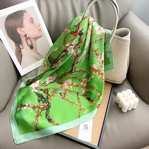 Artistic green silk scarf featuring Van Gogh almond blossom print on a beige handbag