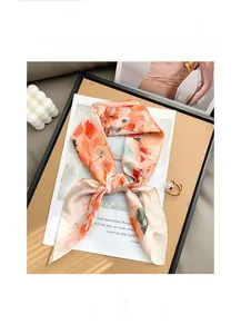 Detail of silk-like floral scarf in peach tones with soft textures and smooth edges