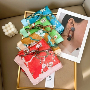 Van Gogh Almond Blossom silk scarves in four elegant colors displayed on a luxury tray