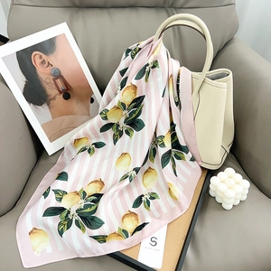 Foulard en soie style français avec imprimé citron et rayures roses sur un sac à main