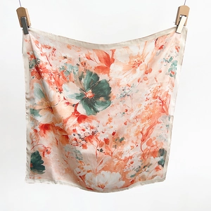 Detailed view of floral silk scarf featuring vintage patterns and smooth satin texture