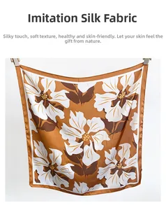 Detail of floral print silk scarf showing smooth satin texture and elegant patterns