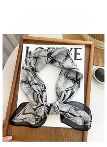 Close-up of elegant lightweight scarf with black and white abstract geometric prints