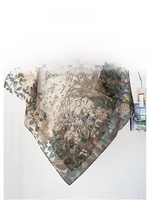 Detail of elegant floral silk scarf with botanical jungle print in olive and tan