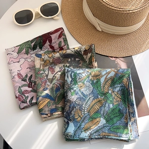 Elegant floral print silk-feel square scarves for women displayed in a resort aesthetic
