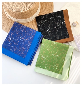 Detailed flat lay of three floral cotton scarves in blue, black, and green colors