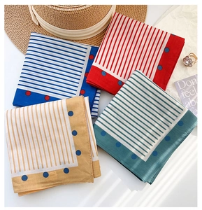 Flat lay of cotton square scarves featuring stripes and polka dots with summer accessories