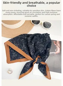 Flat lay of floral cotton scarf with summer straw hat and sunglasses for a vacation style