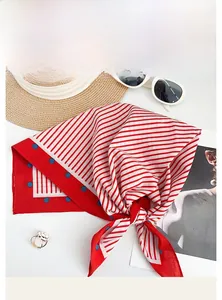 Detail of red and white striped cotton scarf with blue dot edges for summer styling