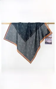 Detail view of the lightweight cotton neck scarf featuring a splattered artistic pattern