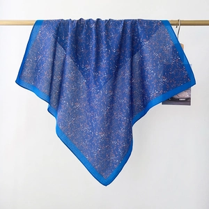 Detailed texture of cotton floral scarf with delicate yellow flowers on navy blue base