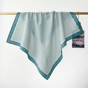 Detail of hanging blue and white cotton scarf with stripes and polka dots texture