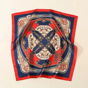 Close-up of printed satin silk scarf with baroque chains and luxury red border