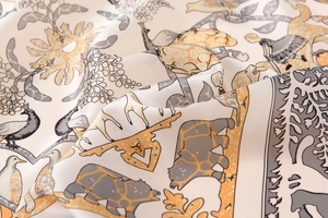 Detail showing high-quality silk scarf fabric with artistic animal print and satin texture